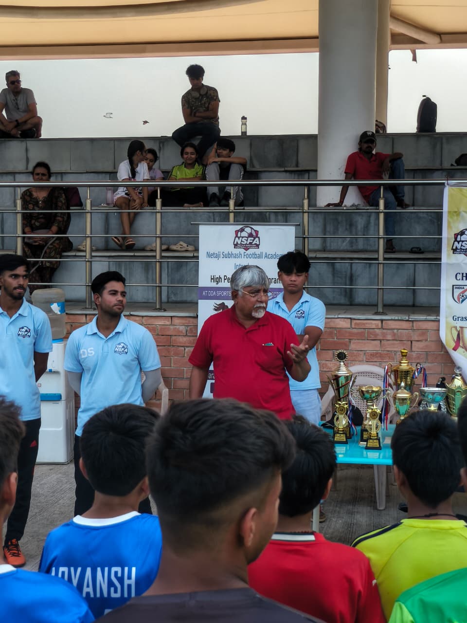 Director addressing players at the championship prize ceremony