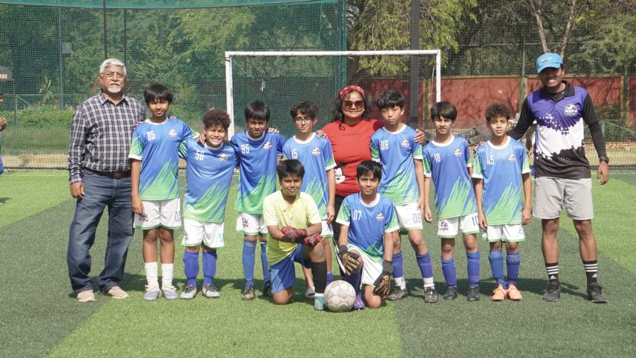 Foundation directors, coaches and squad celebrating tournament milestones